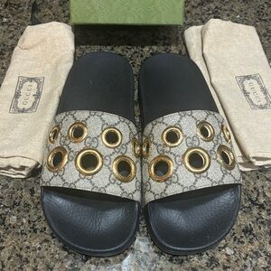 Gucci eyelet slide sandals with Gold Accents